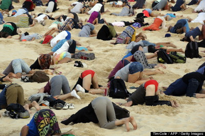Australians protest climate inaction by burying heads in sand on Bondi Beach, November 13, 2014